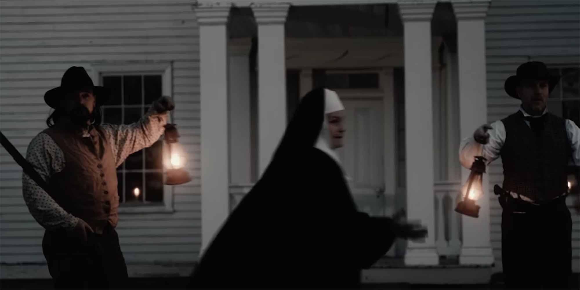 Men waving lanterns as a religious sister arrives